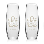 Two clear glasses with 'Mr. & Mrs. Brigham' engraving on a white background