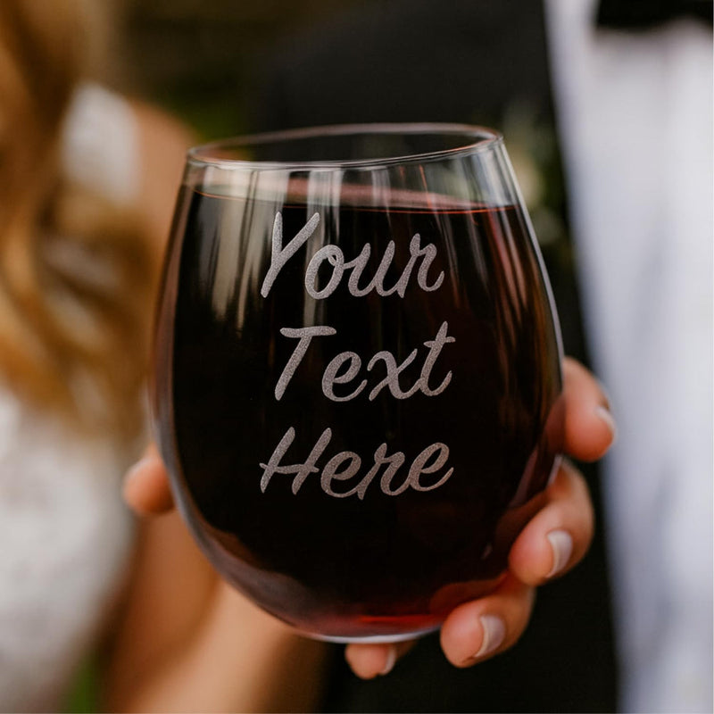 Wine glass with 'Your Text Here' text held by a person.
