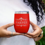 Red tumbler with 'HARPER' printed on it held by a person.