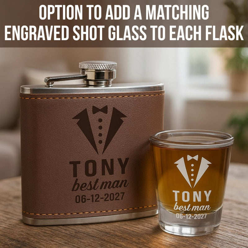 Brown leather flask and matching shot glass with engraved text on a wooden surface.