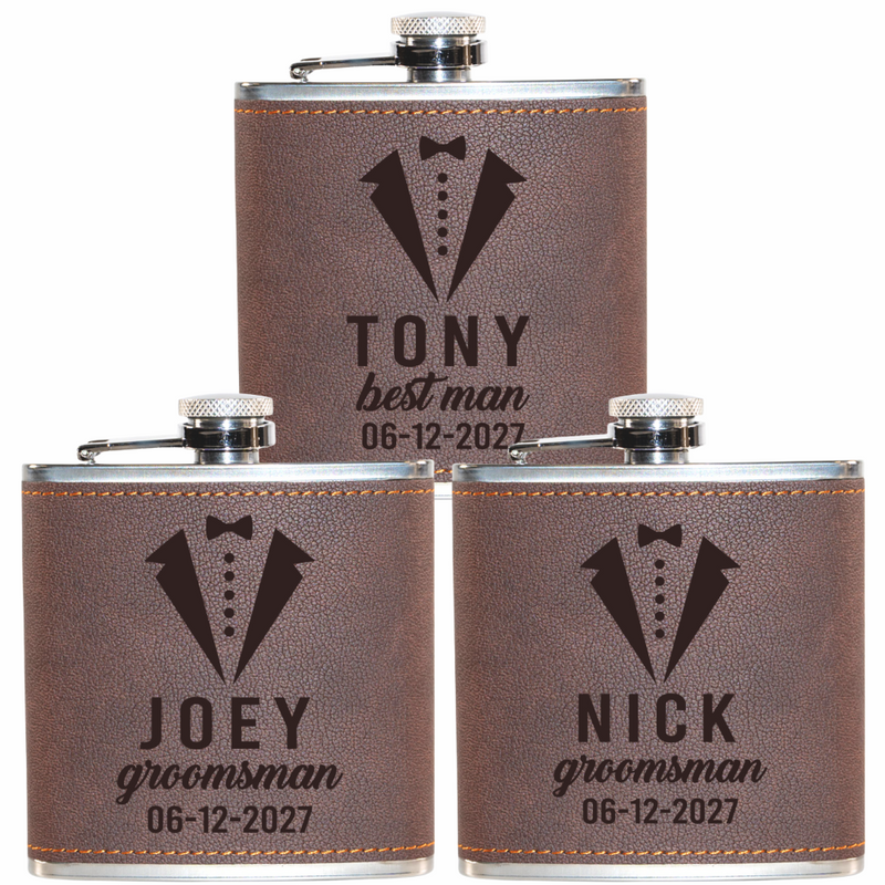 Three leather-wrapped flasks with engraved names and dates on a white background