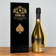 custom engraved gold painted ace of spades box next to an engraved ace of spaced champagne bottle 