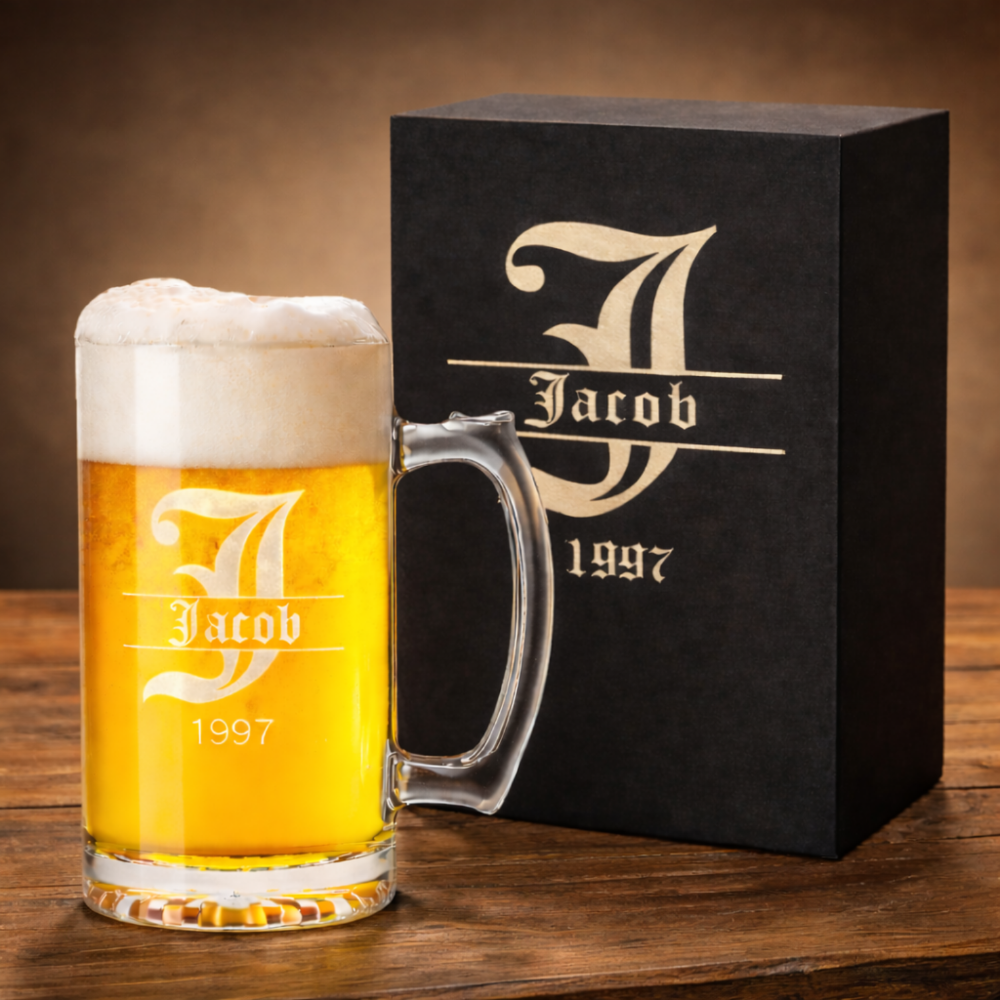 Beer mug with foam and a black box featuring 'Jacob 1997' branding on a wooden surface.