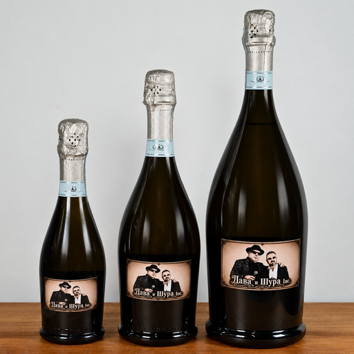 Three dark glass champagne bottles of different sizes arranged by height on a wooden surface against a light gray background. Each bottle has a custom vintage-style label featuring a black-and-white portrait of a man and woman with the text 'Mama & Sypia'.