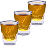 Three shot glasses with 'Peterson' engraving on a white background