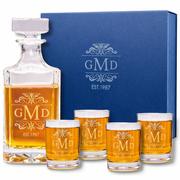 Alcohol decanter set with glasses featuring 'GMD' branding and a blue gift box.